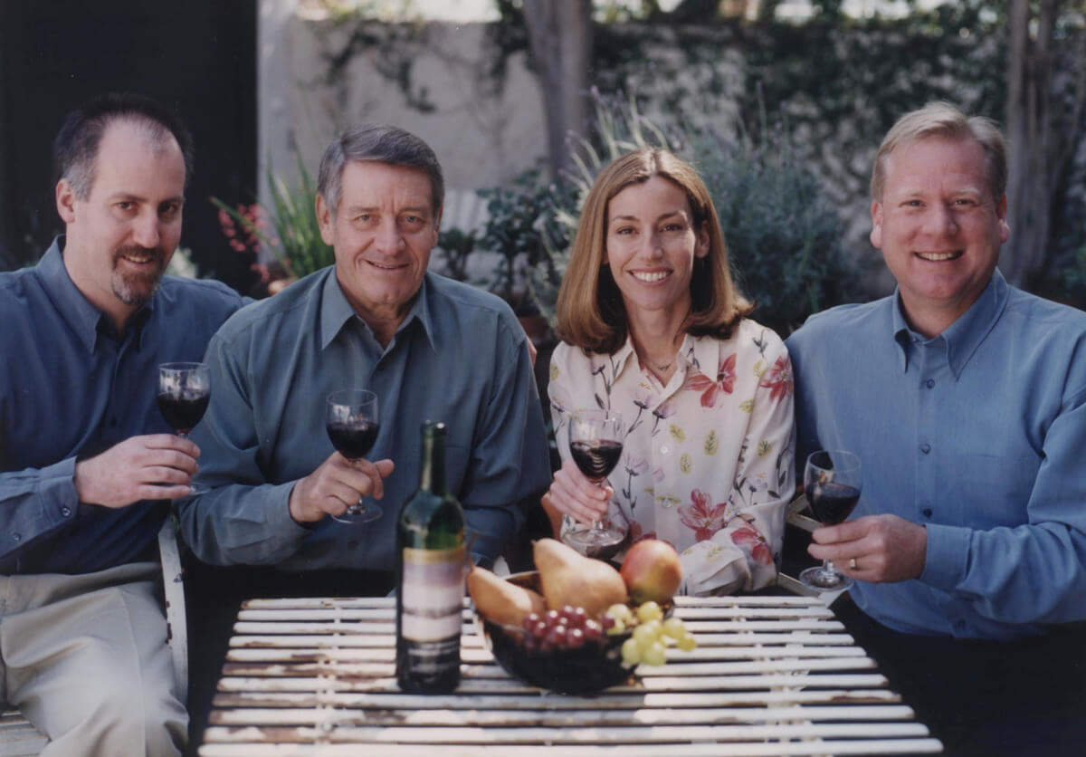 Gang of Four holding wine glasses