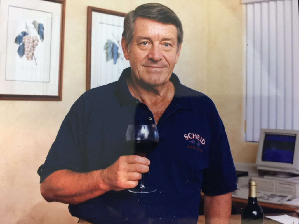 Al Scheid wearing Scheid shirt and holding glass of wine