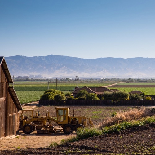 Farm tractor and barn at Scheid vineyards