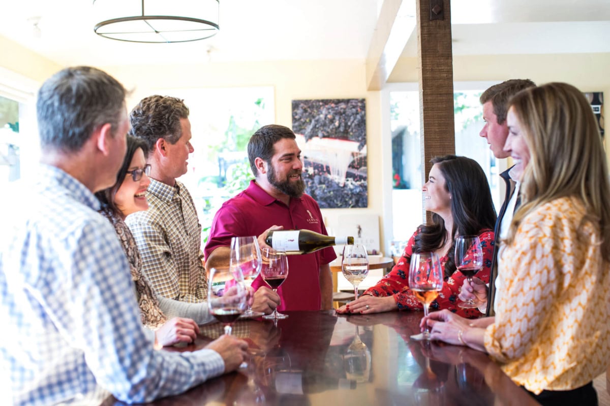 Elegant wine tasting at Scheid Vineyards showcasing premium wines in a welcoming winery setting.