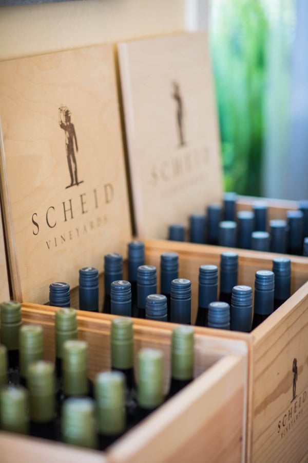 A collection of wine bottles stored in wooden cases at Scheid Vineyards.