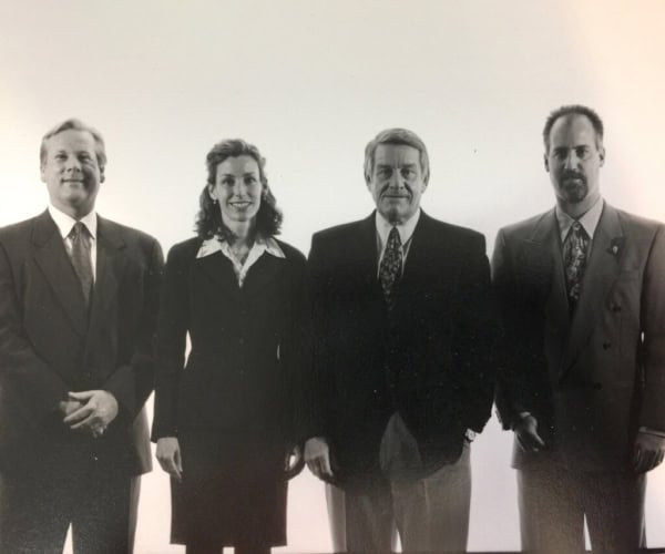 Elegant group photo of Scheid Vineyards team in formal attire, emphasizing wine industry professionalism.