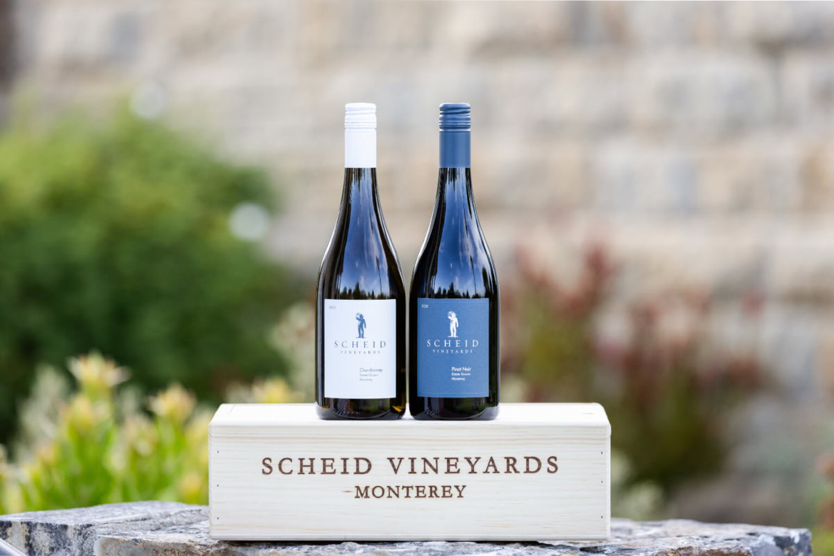 Vineyard wine bottles on wooden display, Scheid Vineyards Monterey.